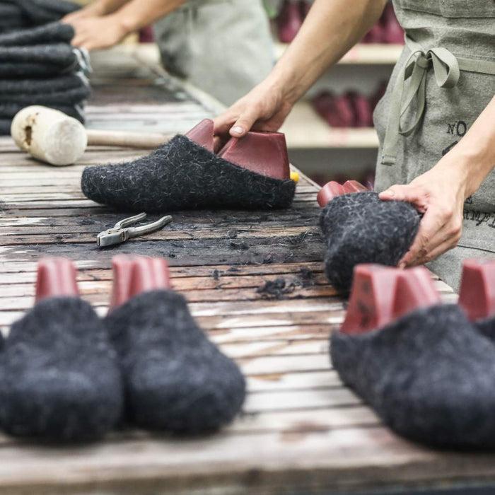 Artisan hand making wool slippers