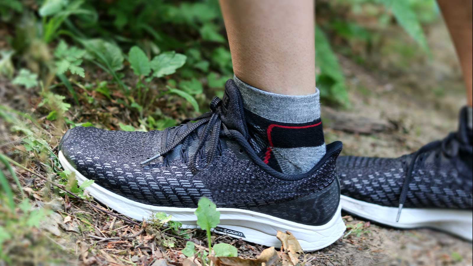 Man wearing shoes with Nootkas Alpaca Sports Socks in Black